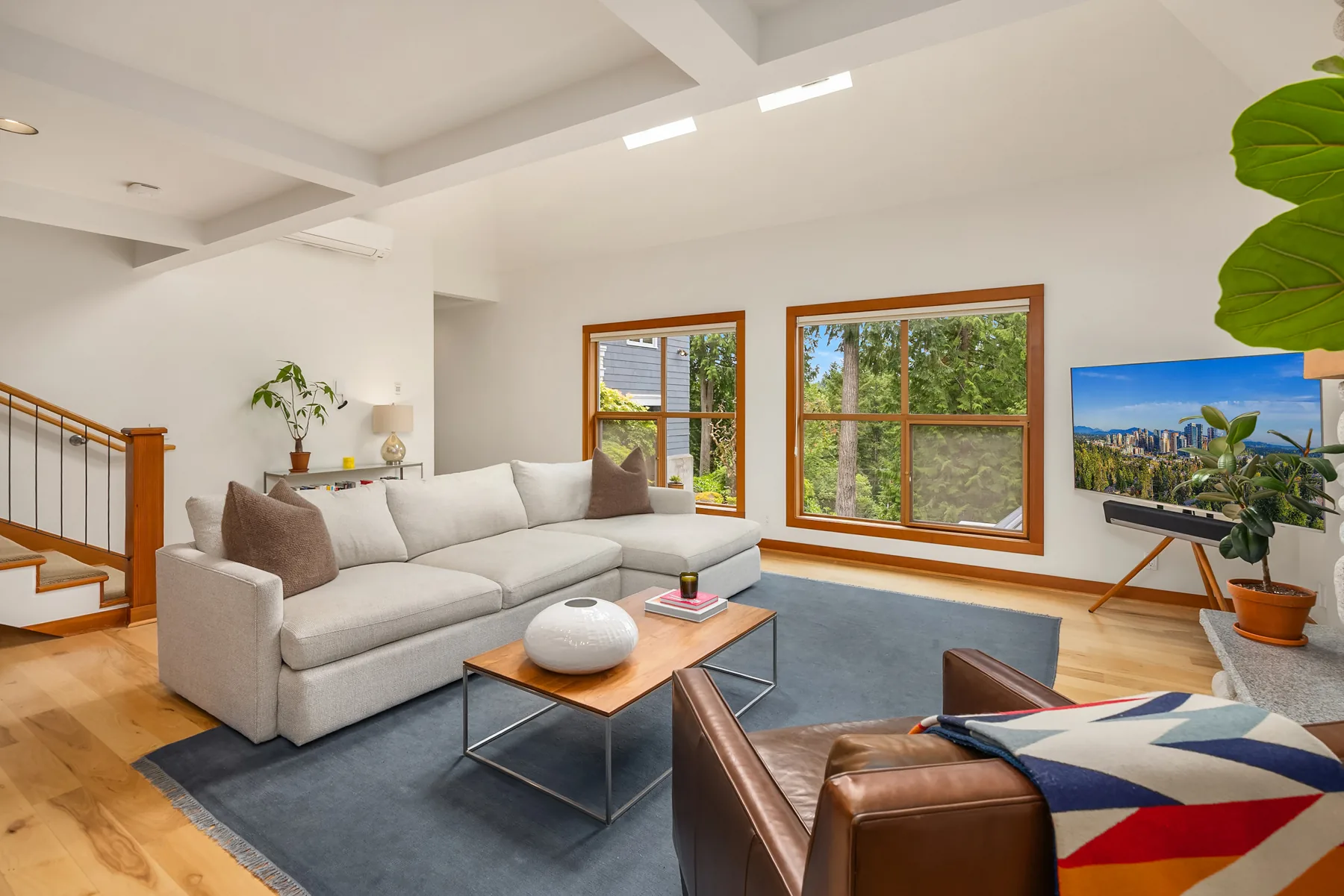 Upstairs living room with sectional sofa, skylights, and territorial views